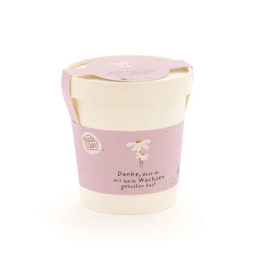 Weicher pink-cremefarbener danke wachsen becher mit zarter gänseblümchen-illustration als ökologische baby- & kinderprodukte
