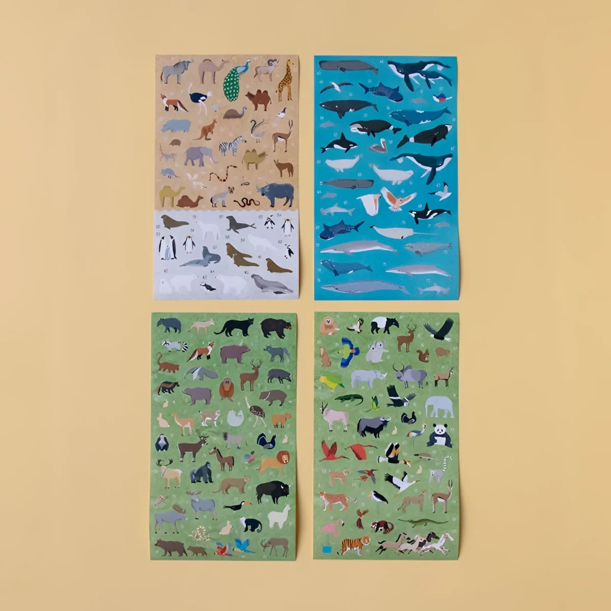Vier illustrierte Stickerbögen mit diversen Tieren in bunten Cartoon-Designs auf Papier, aus Animal World Poster + Stickers
