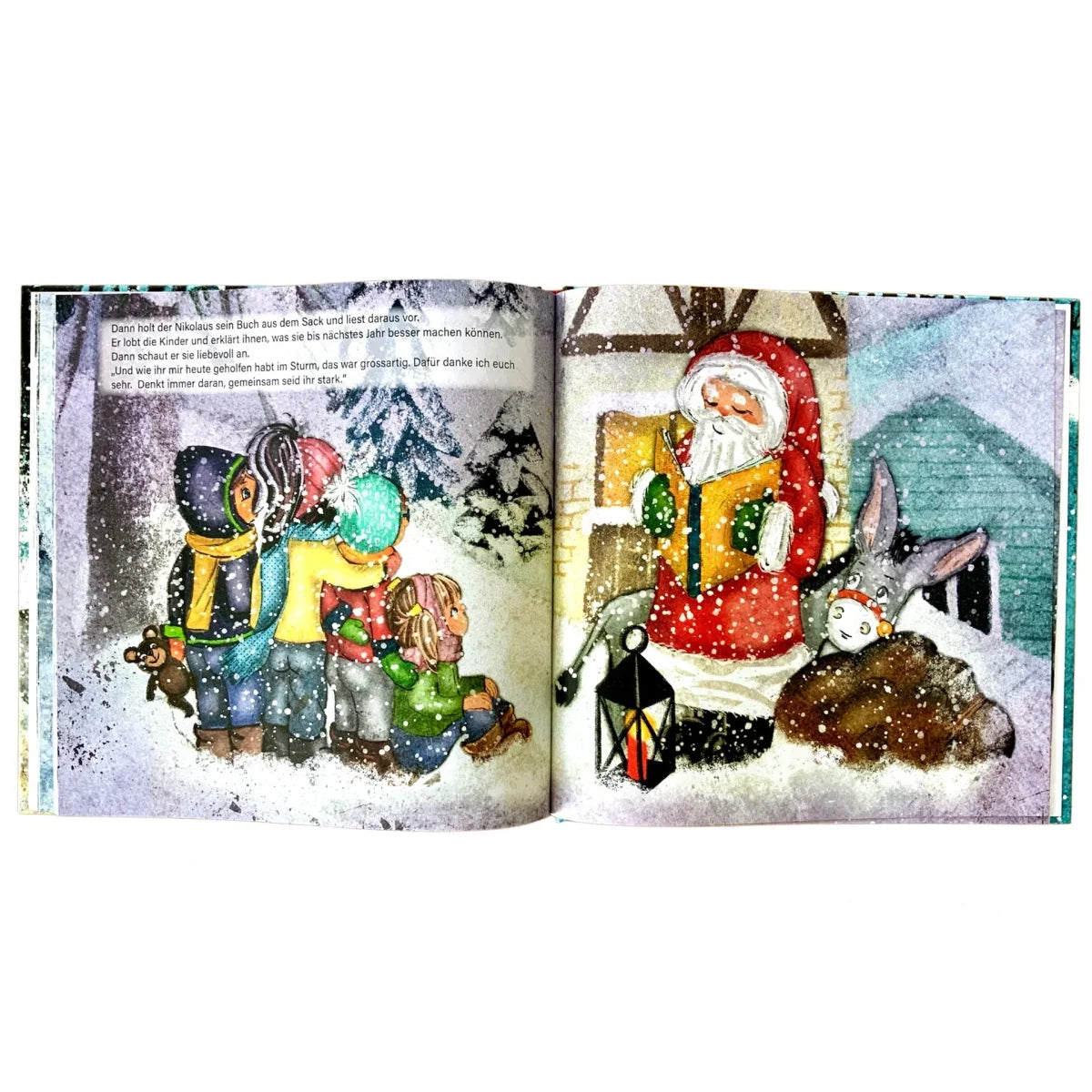Offenes Bilderbuch mit bunten Winterillustrationen von Nikolaus und spielenden Kindern