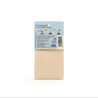 Beige rechteckige samenpackung bunt blumenmurmeln mit blauem etikett und pflanzenillustrationen für ökologische