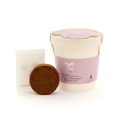 Danke wachsen becher in rosa und creme mit henkel und blumendesign für ökologische baby- & kinderprodukte