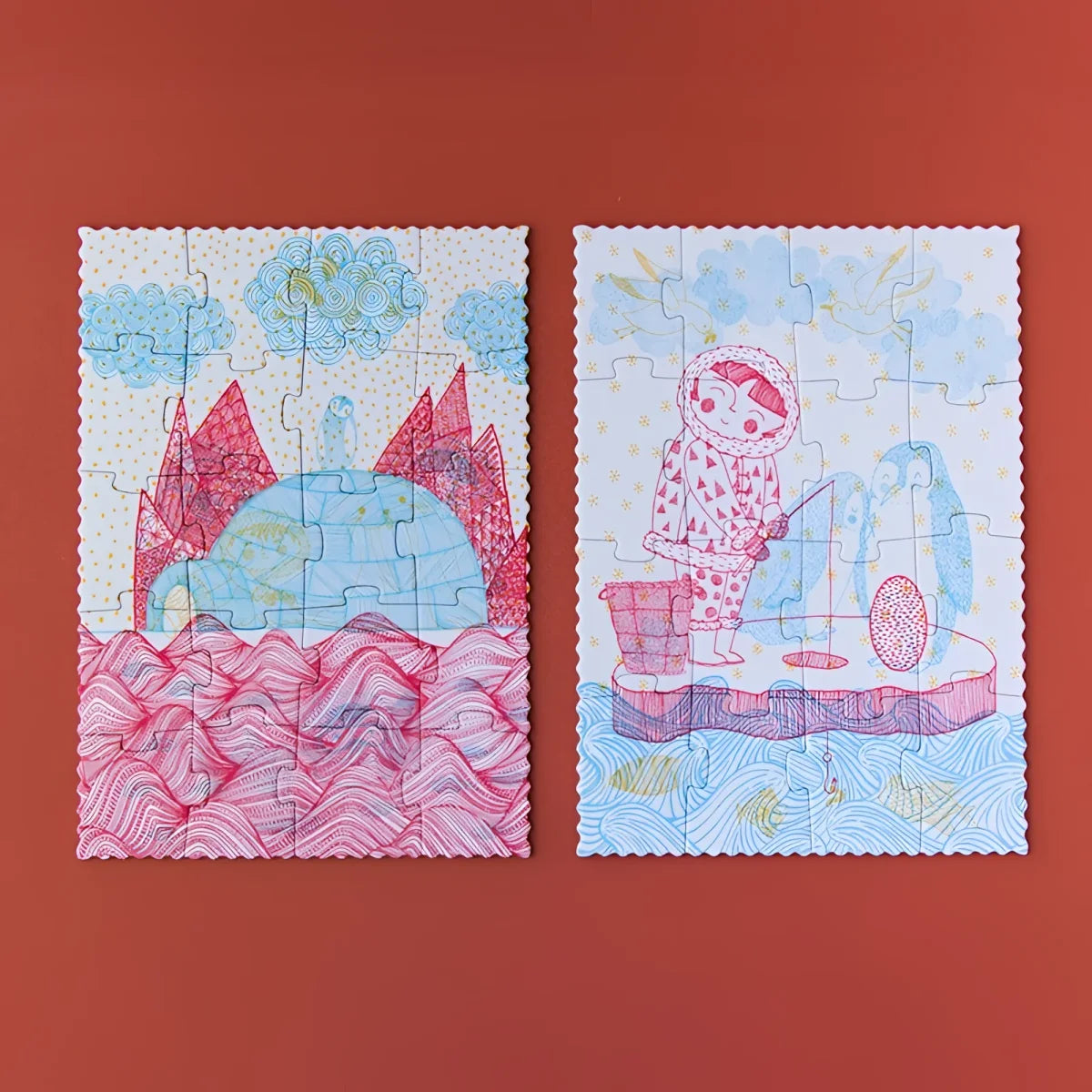 Zwei illustrierte Puzzles mit skurrilen Arktisszenen in Pink und Blau