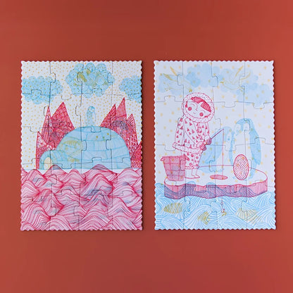 Zwei illustrierte Puzzles mit skurrilen Arktisszenen in Pink und Blau