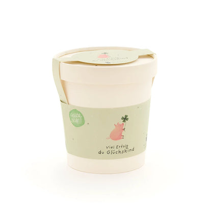 Glückskind becher aus pastellgrünem und cremefarbenem papier mit süßem rosa schwein und vierblättrigem klee