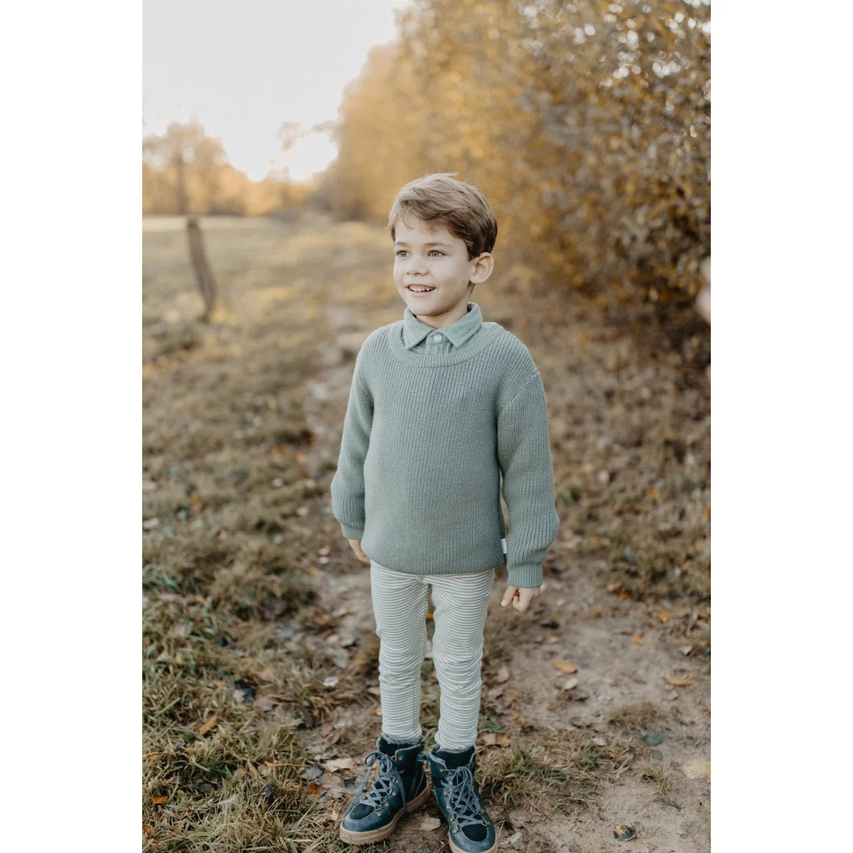 Junge in weichem salbeigrünem Strickpullover mit Jersey-Leggings Grün Gestreift