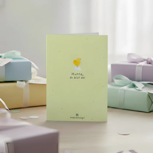 Pale green greeting card with yellow chick illustration and black text hurra du bist da perfect for newborn wishes