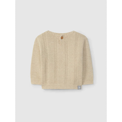 Helles cremefarbenes Langarmstrickpullover mit offenen vertikalen Mustern und Holzknopf