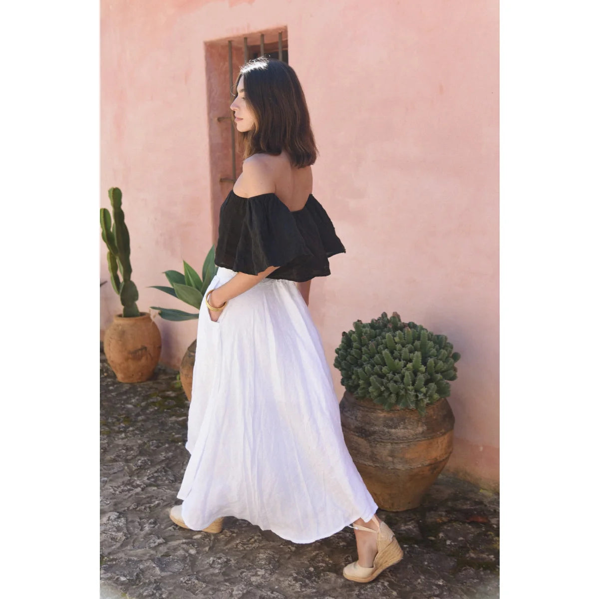 Frau in schwarzem Off-Shoulder-Top und weißem Maxirock, Leinen Rock Alba Blanco