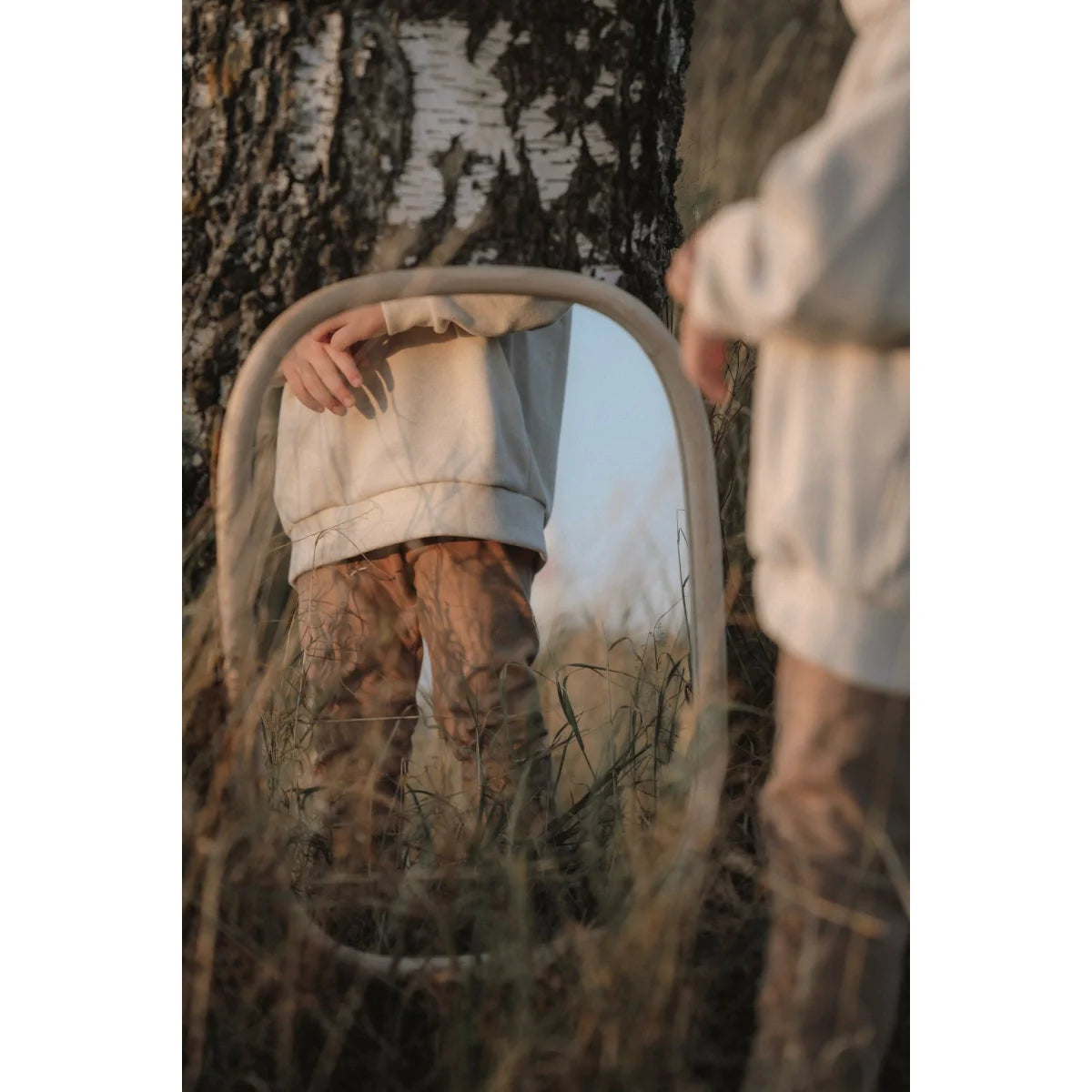 Oval mirror in tall grass and foliage enhancing Loose fit Pants by Kakao