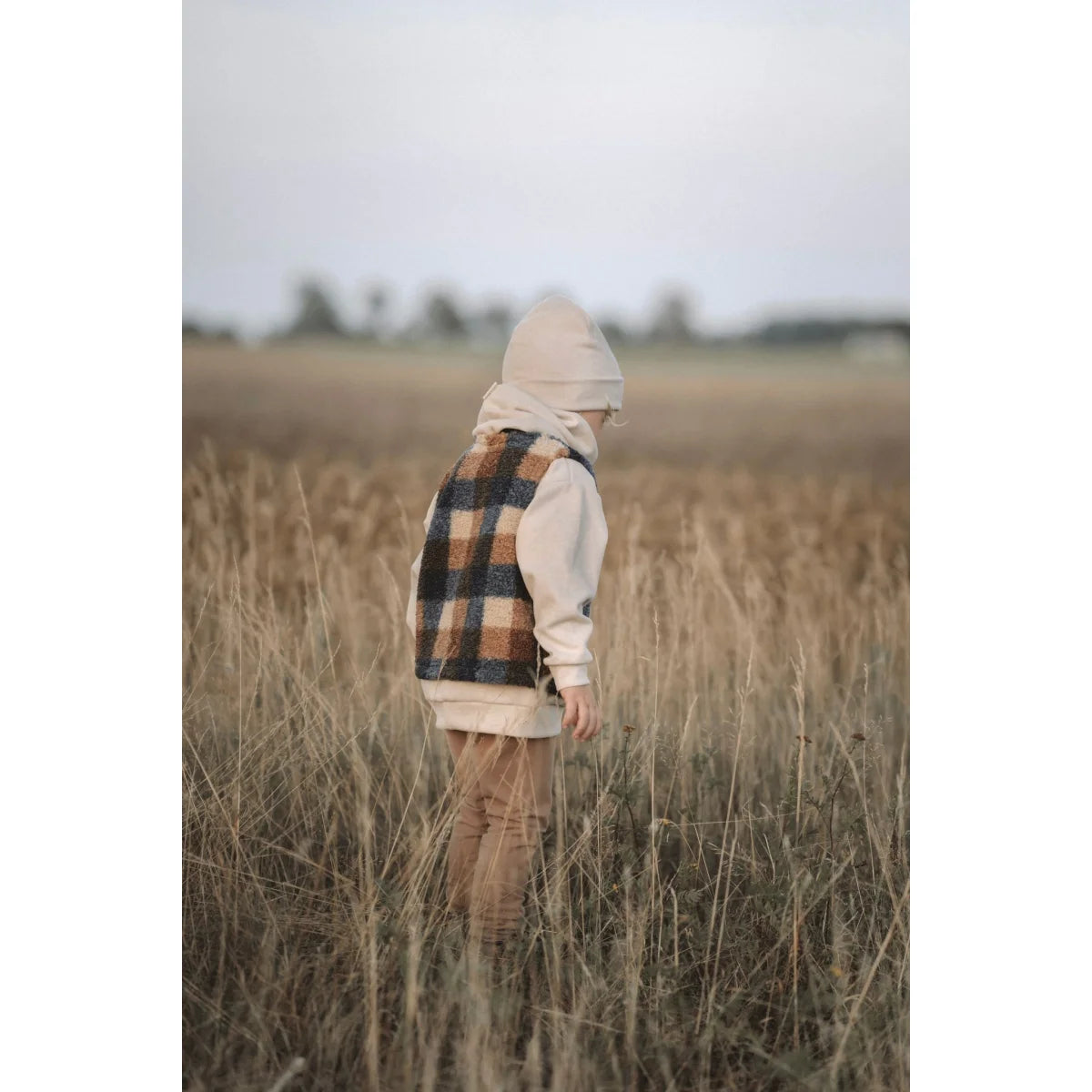 Plaid Vest and Cream Hoodie Outfit in Tall Grass with Loose Fit Pants from Kakao