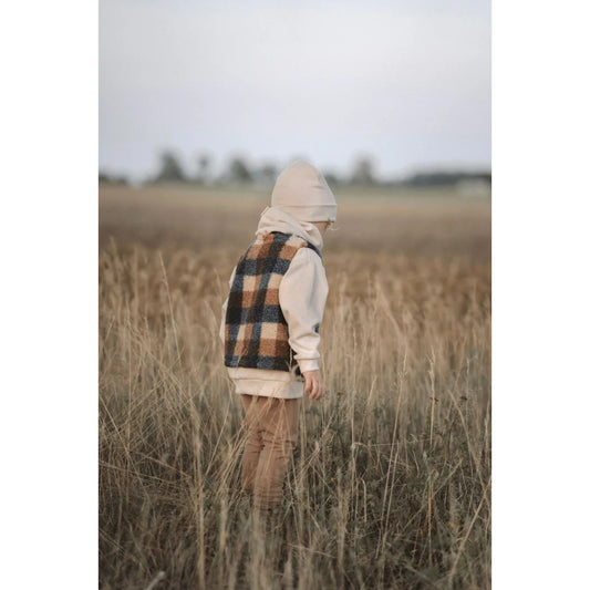 Plaid Vest and Cream Hoodie Outfit in Tall Grass with Loose Fit Pants from Kakao