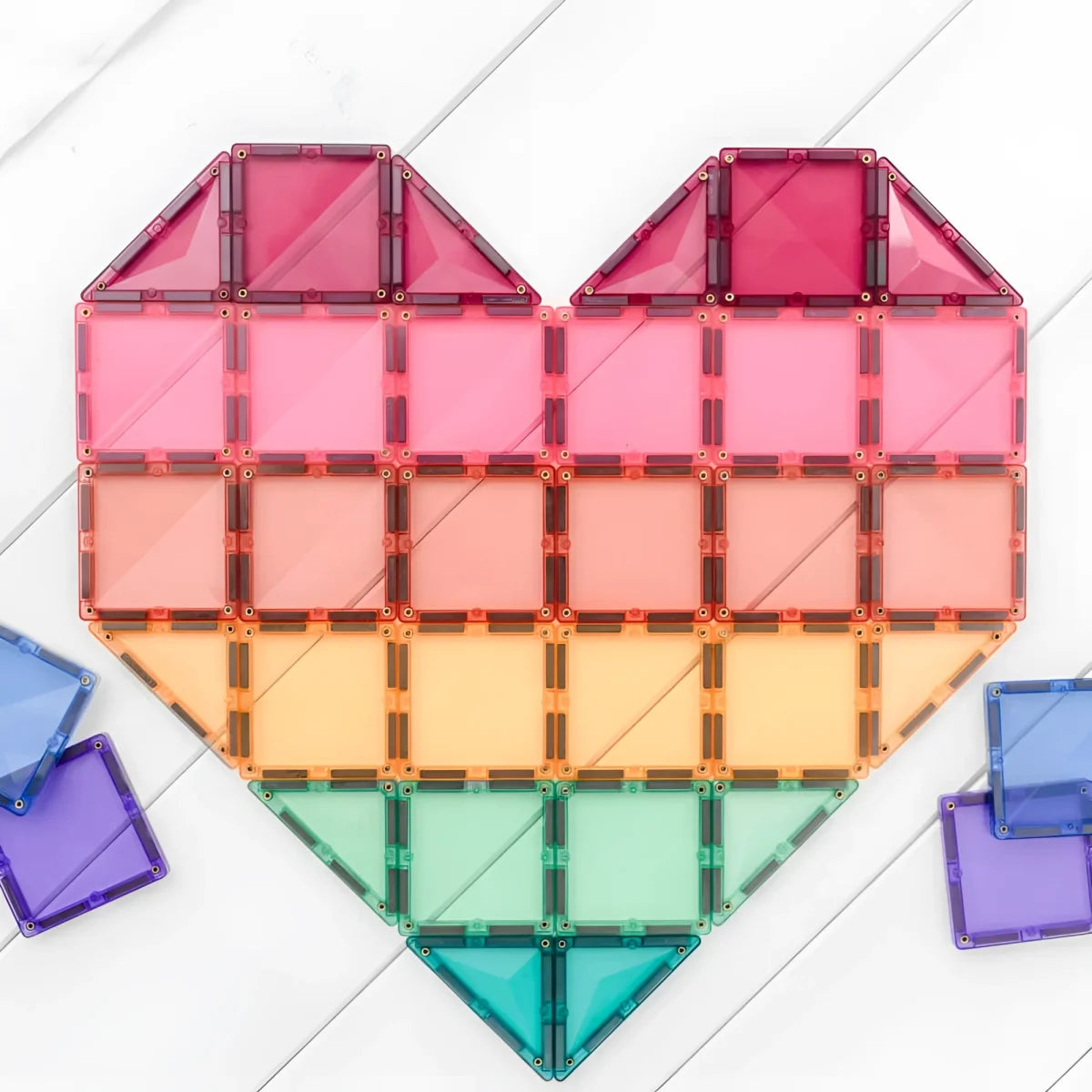Herzförmige Anordnung farbenfroher, durchsichtiger geometrischer Fliesen im Regenbogenstil