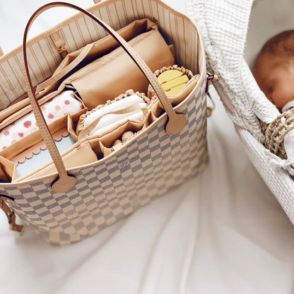 Beige Mom Bag Organizer filled with baby essentials and accessories in a woven tote