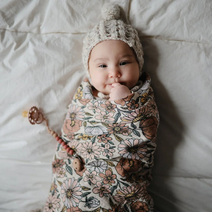 Baby in Floral Swaddle and Knitted Hat from Mulltuch Retro Flowers Collection