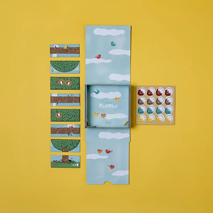 PIU PIU Tiny Game: Bunte Vogel-Aufkleber auf Puzzle-Box mit Himmel-Design