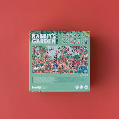 Brettspielverpackung zu Rabbit’s Garden mit bunten Kaninchen und Blumen auf grünem Hintergrund