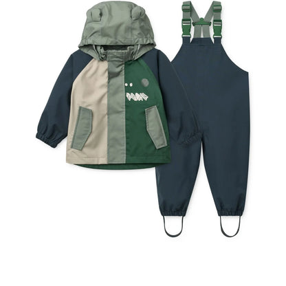 Kinder-Regenbekleidungsset Manu Play Multi Mix mit Regenjacke und Latzhose in Olivgrün, Marineblau und Beige mit Dino-Motiv