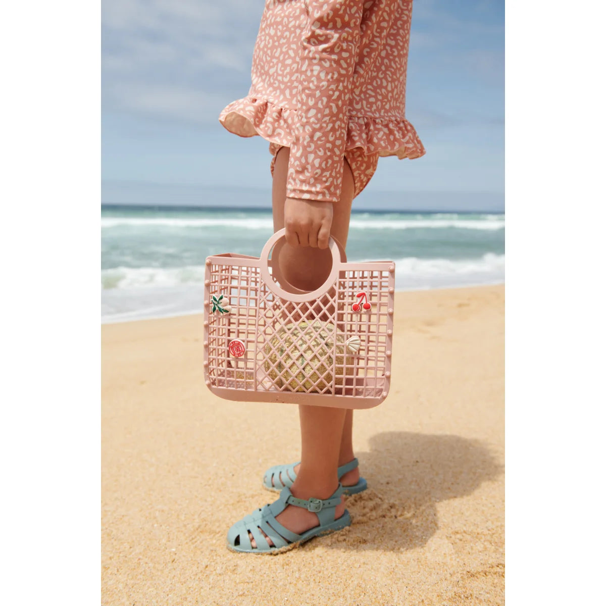 Pink latticed plastic tote bag with flamingo decorations by Samantha Korb