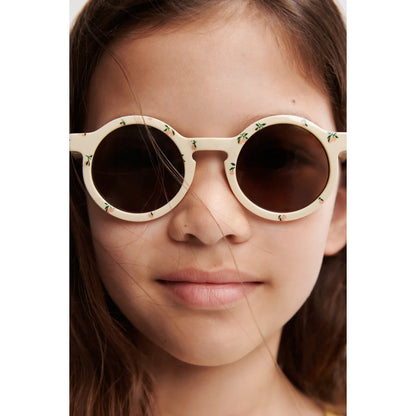 Darla Sonnenbrille für Kinder: Cremefarbene runde Brille mit Blüten-Dekor aus recyceltem Polycarbonat