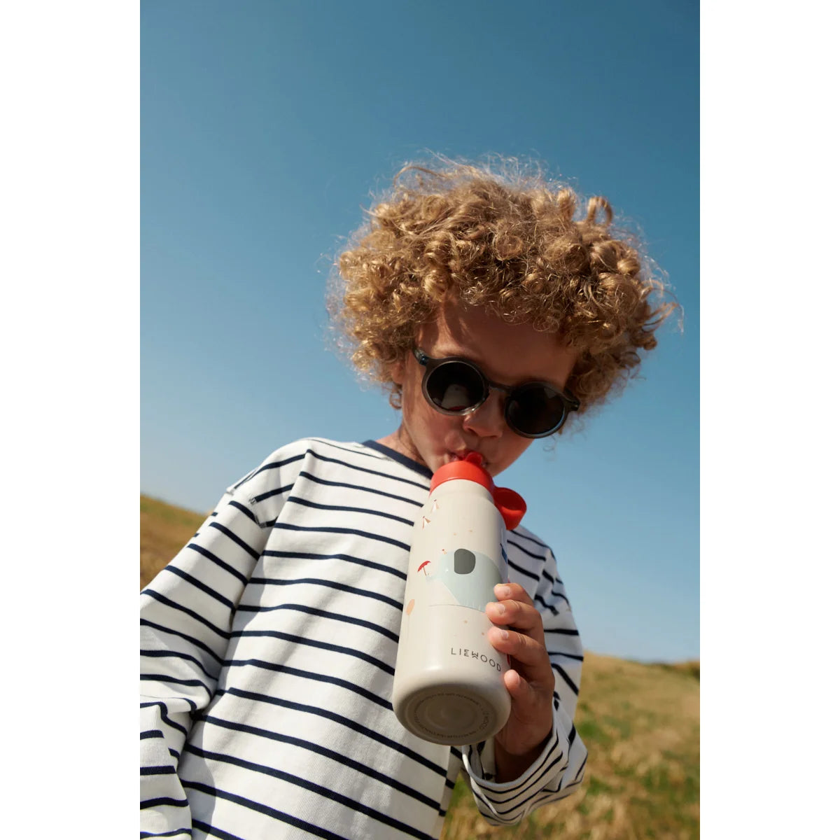 Weiße isolierte Wasserflasche mit rotem Deckel und bunten Illustrationen, Lieblo, Darla Sonnenbrille Whale Blue transparent
