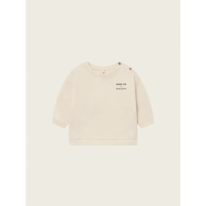Helles langärmliges Baby-Sweatshirt mit Schulterknöpfen aus der Forest Song Undyed Kollektion