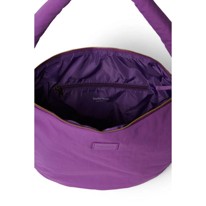 Textured puffy cross body bag in purple with soft quilted exterior and gold-toned zipper accents